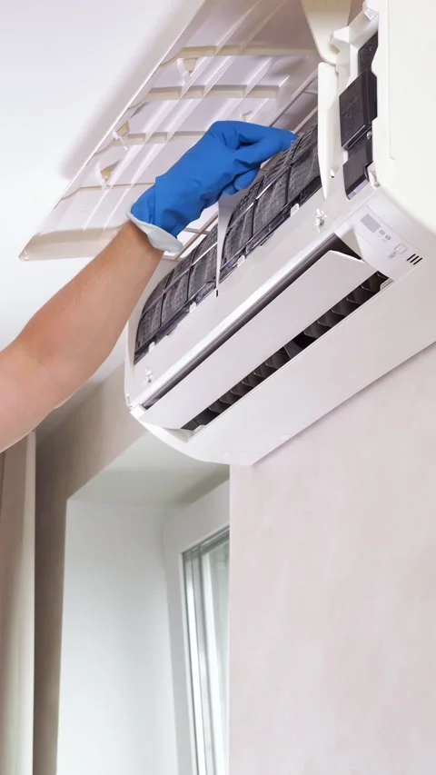 Technician Services Air Conditioner Unit Indoors While Wearing Protective Blue Stock Footage 346989173