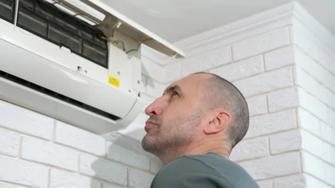 Technician servicing wall white conditioner indoor. Stock Footage 291590705