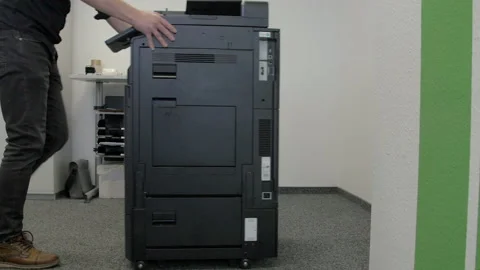 Technician sets up a multi-function copier device. Stock-Footage 170738332