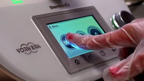 Technician sets timer on compact food processor in prep kitchen Stock Footage 315218401