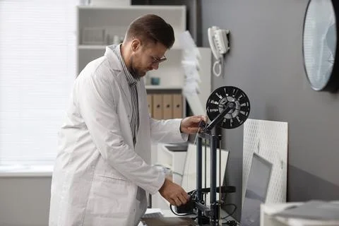 Technician Setting up 3D Printer 写真素材