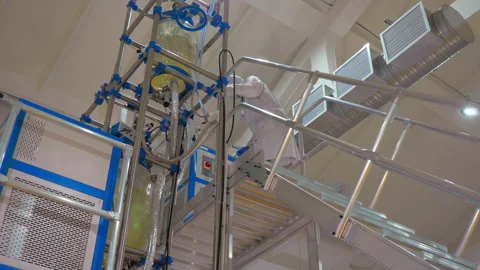A technician setting up the machine at the industrial pharmaceutic factory Stock Footage 252494437