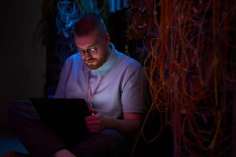 Technician Setting Up Network in Data Center Sitting on Floor Stock Photos