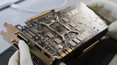Technician setting a video card to the mother-board of a personal computer Video stock 89900408