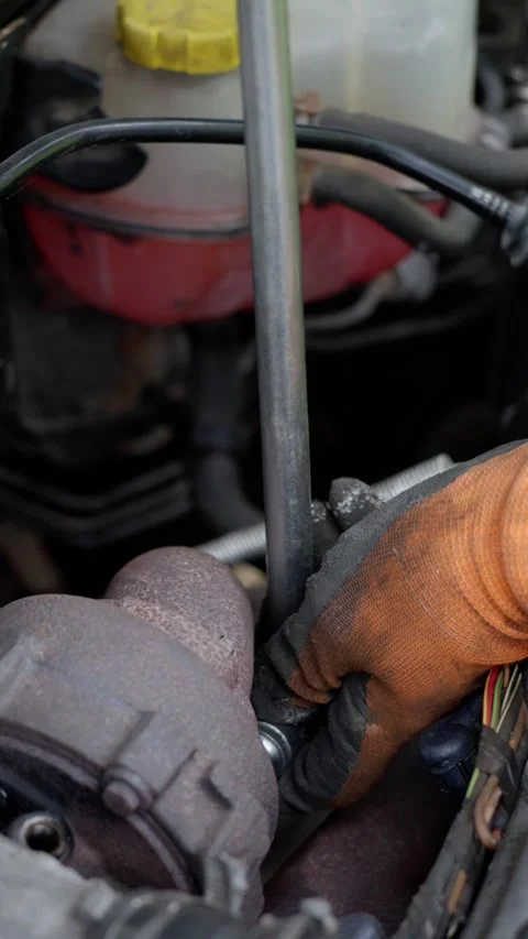 A technician skillfully repairing an engine with a wrench, demonstrating Stock Footage 308234089