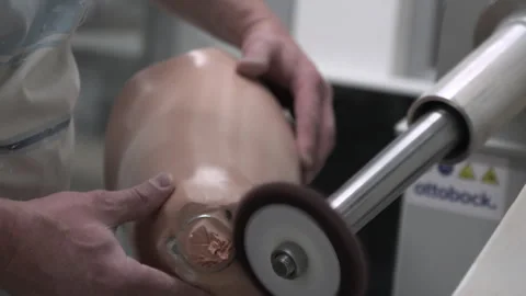 Technician smoothing prosthetic socket with rotary tool during fabrication Stock Footage 329387162
