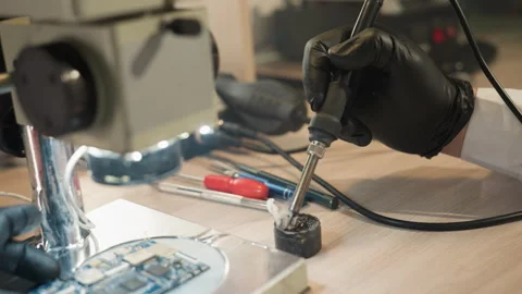 Technician Soldering Circuit Board Under Microscope in Lab Stock Footage 282301706