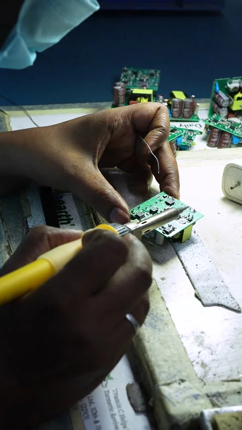 Technician Soldering Electronic Circuit Board in Noida Workshop Stock Footage 345809258