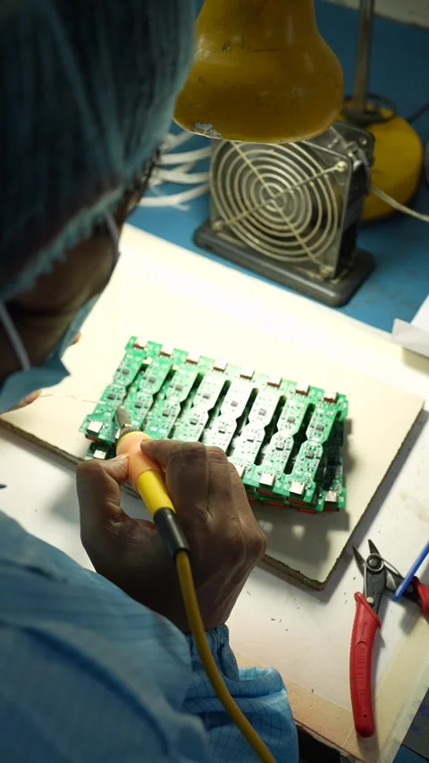 Technician Soldering Electronic Circuit Board in Noida Factory Stock Footage 345809334