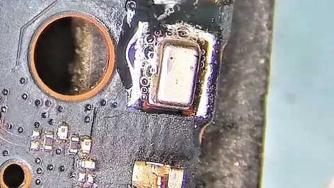 Technician Soldering IC Chip on Mobile Phone Motherboard Macro Stock Footage 333900100