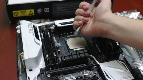 Technician squeeze a thermal compound (thermal paste) onto a computer processor  Video stock 102191811