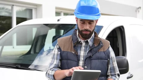 Technician standing by van and using tablet Video stock 64761372