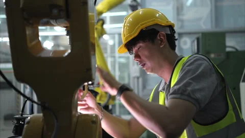 A technician suffers a hand accident while working with a robot arm Stock Footage 266701905
