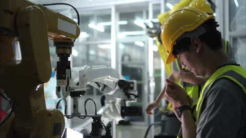 A technician suffers a hand accident while working with a robot arm Stock Footage 266702452