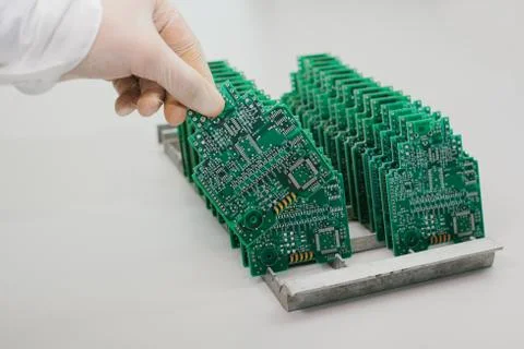 The technician takes a computer board with chips. Spare parts and components for Foto stock