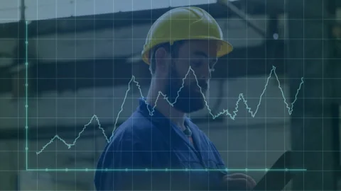 Technician tapping tablet on factory floor, monitoring data graph spiking during Stock Footage 312003439