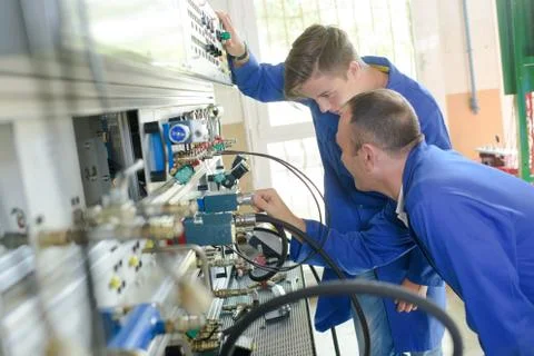 A technician teaching the machine concept Stock Photos