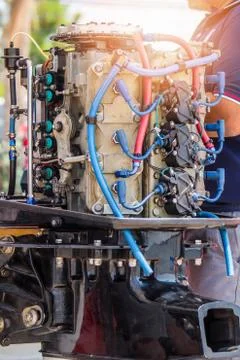 The technician team is checking the engine of the boat before contest. Stock Photos