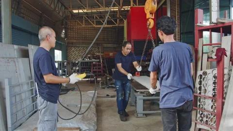 Technician team using hoist crane for lifting metal sheet in workshop factory Stock Footage 204055292