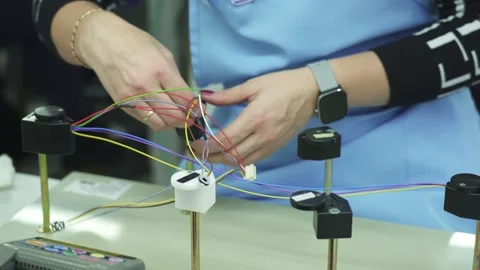 A technician is testing an automotive cable harness. Close-up Stock Footage 321896942