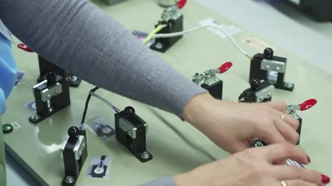 A technician is testing an automotive cable harness Stock Footage 321896970