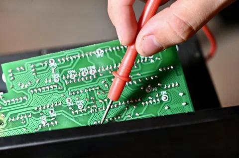 Technician Testing Circuit Board with Multimeter Probe Close-up Stock Photos