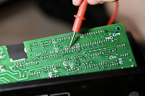Technician Testing Circuit Board with Multimeter Probe Close-up Stock Photos