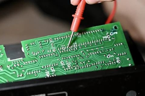 Technician Testing Circuit Board with Multimeter Probe Close-up Stock Photos