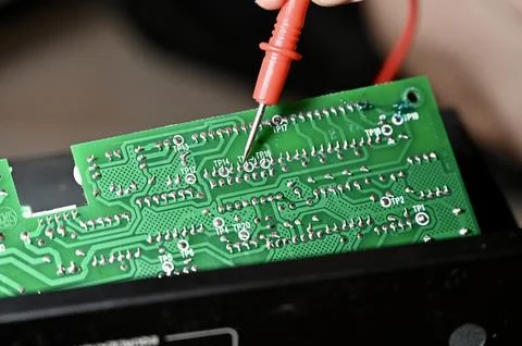 Technician Testing Circuit Board with Multimeter Probe Close-up Stock Photos
