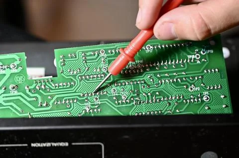 Technician Testing Circuit Board with Multimeter Probe Close-up Stock Photos