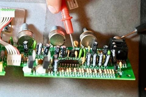 Technician Testing Circuit Board with Multimeter Probe Close-up Stock Photos