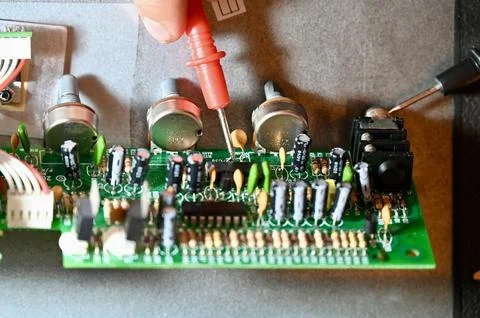 Technician Testing Circuit Board with Multimeter Probe Close-up Stock Photos