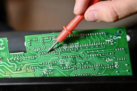 Technician Testing Circuit Board with Multimeter Probe Close-up Stock Photos