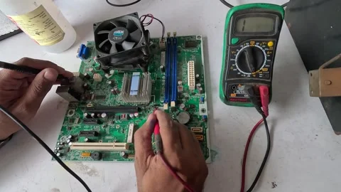 Technician testing computer motherboard with electrical equipment Stock Footage 247818343