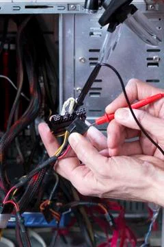 Technician is testing the electrical power of power supply Stock Photos