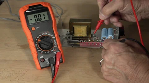 A technician testing voltages on electronic equipment Stock Footage 243998134