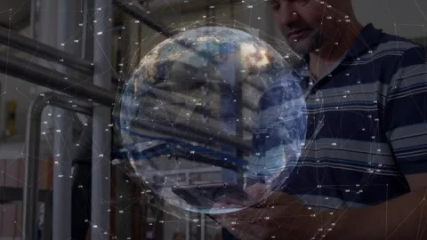 Technician touching tablet at plant showing spinning 3D globe pulsing nodes for Stock Footage 329569198