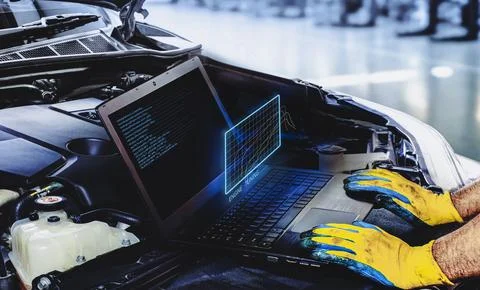 Technician is tuning engine car with a computer software Foto stock