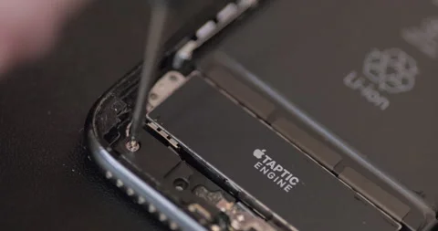 Technician unscrews tiny bolt to fix Smartphone / Iphone - 4K Stock Footage 295003656