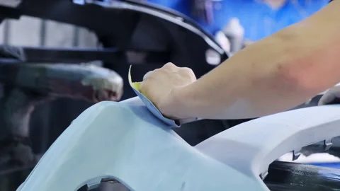 Technician uses cloth to remove dust from surface of part Stock Footage 317634799