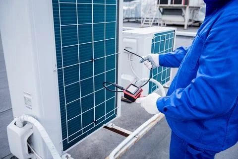 The technician uses a digital camera to check the clogging of the heat exchanger Stock Photos