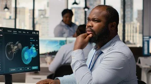 Technician uses software to plan wind farm layout, determining turbine placement Foto stock