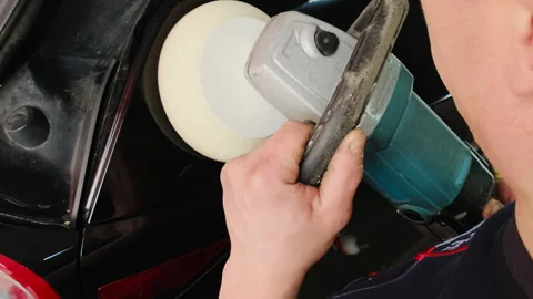 Technician uses special tool to remove dent on car Video stock 316184156