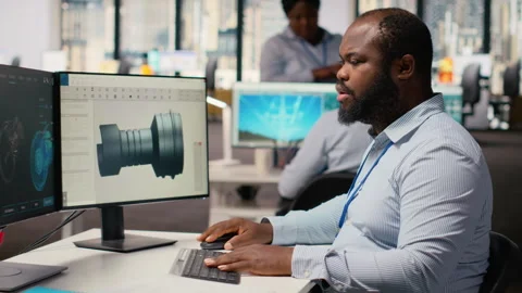 Technician using CAD program on PC to optimize wind turbine design Stock Footage 315614039