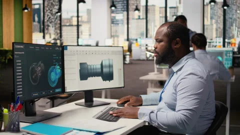 Technician using CAD program on PC to optimize wind turbine design Stock Footage 316005939