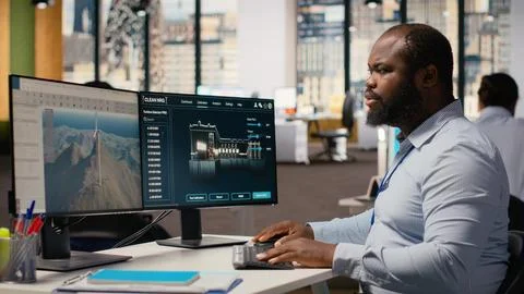 Technician using CAD software to optimize wind turbine blade aerodynamics 스톡 사진