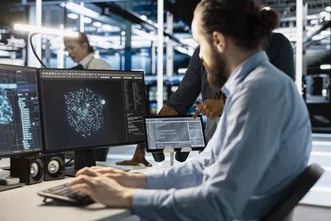 Technician using computer in data center, running scripts Stock Photos