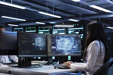 Technician using computer to do checkup in AI server room Stock-Fotos