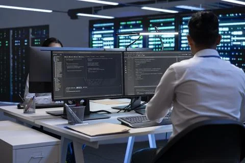 Technician using computer to troubleshoot hardware in server hub 스톡 사진