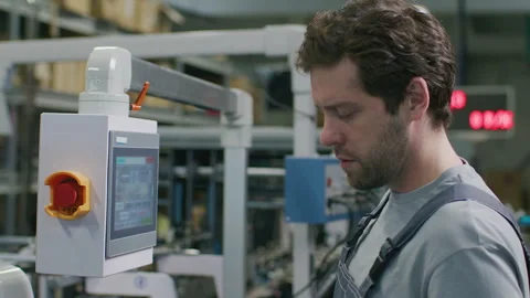 Technician Using Control Panel of Printing Machine in Commercial Print Shop Stock Footage 335485586